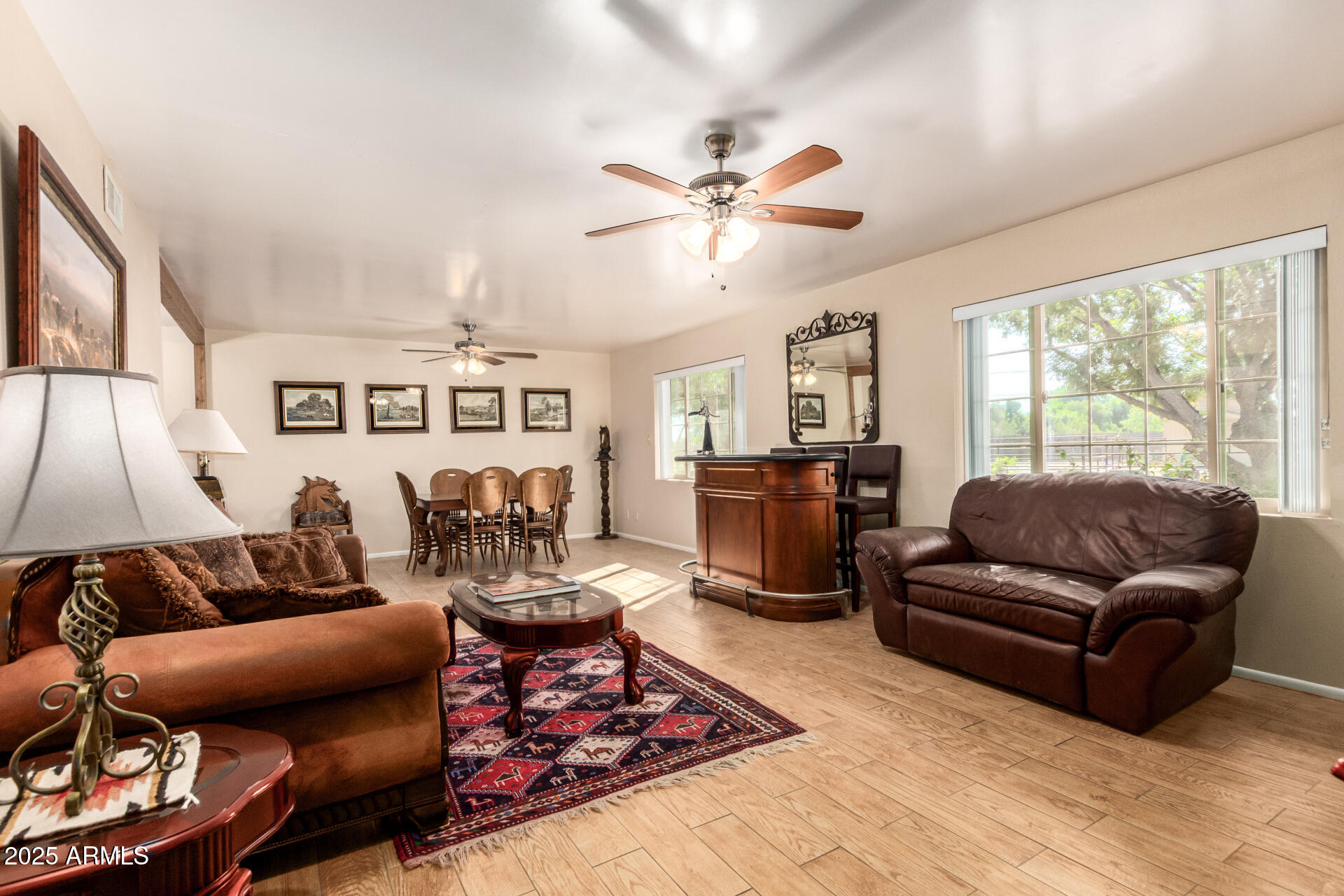 6419 East Cactus Road Scottsdale, AZ 85254 - Photo 3 of 38 a living room with furniture ceiling fan and a rug
