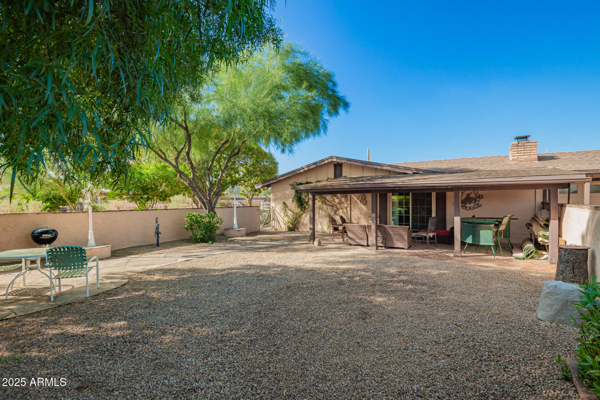 6419 East Cactus Road Scottsdale, AZ 85254 - Photo 32 of 38 a view of patio with a table and chairs under an umbrella