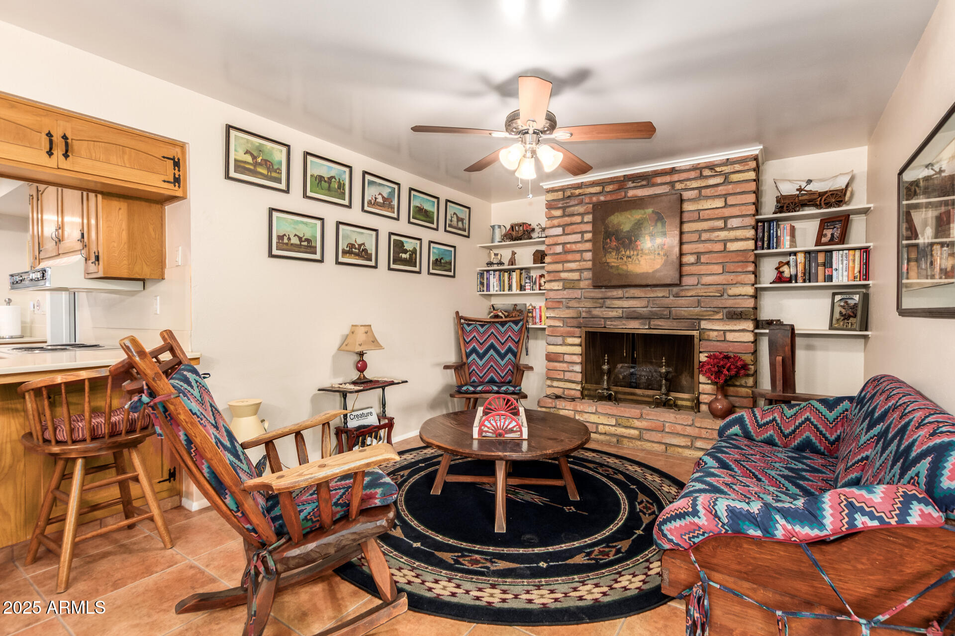 6419 East Cactus Road Scottsdale, AZ 85254 - Photo 4 of 38 a living room with furniture a fireplace and a chandelier