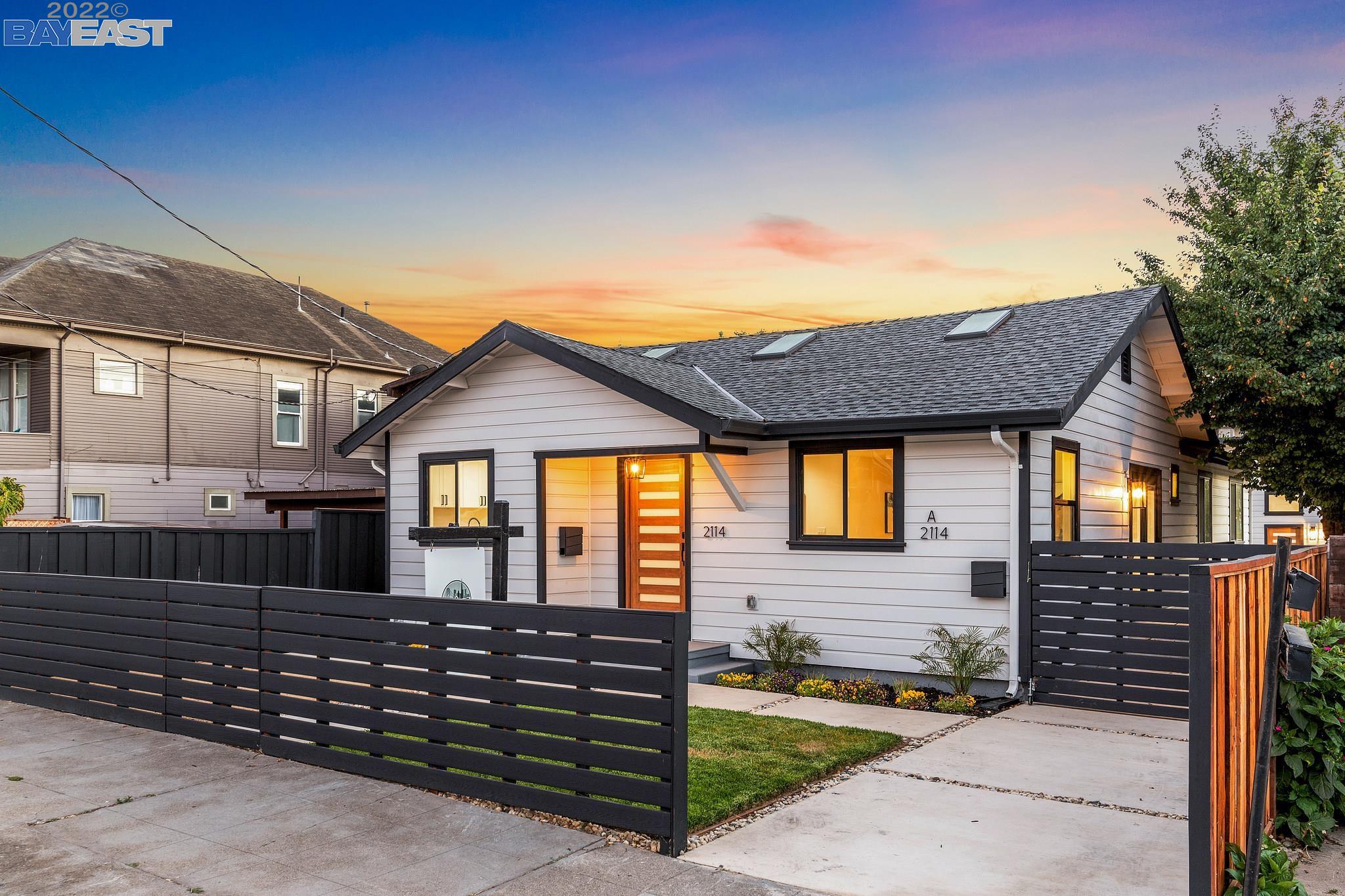a view of a house with wooden fence