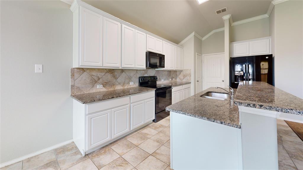 3101 Buckthorn Street Forney, TX 75126 - Photo 6 of 40 Kitchen featuring white cabinetry, granite countertops, tile flooring, tile backsplash, and black appliances
