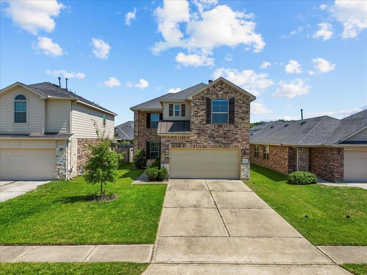 5111 Bay Lane Bacliff, TX 77518 - Photo 2 of 48 a front view of a house with a yard and garage