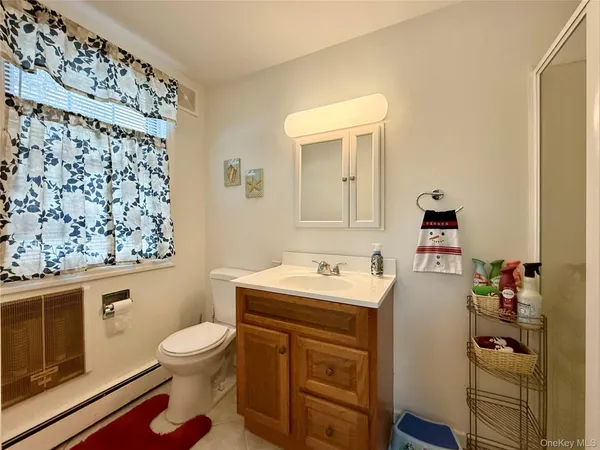 a bathroom with a sink toilet and mirror
