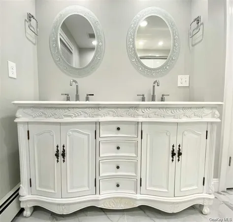 a bathroom with a granite countertop double vanity sink and a mirror