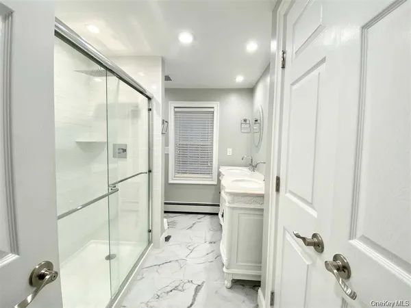 a bathroom with a shower and a tub
