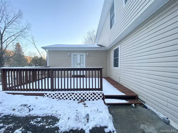 a view of a wooden bench in the backyard