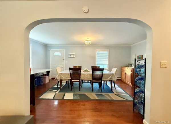 a view of a dining room with furniture and wooden floor