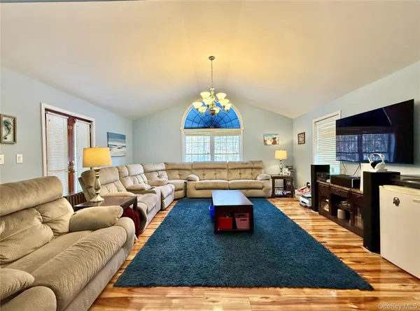 a living room with furniture rug and window