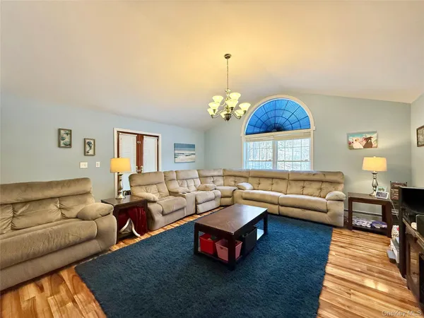 a living room with furniture and a chandelier