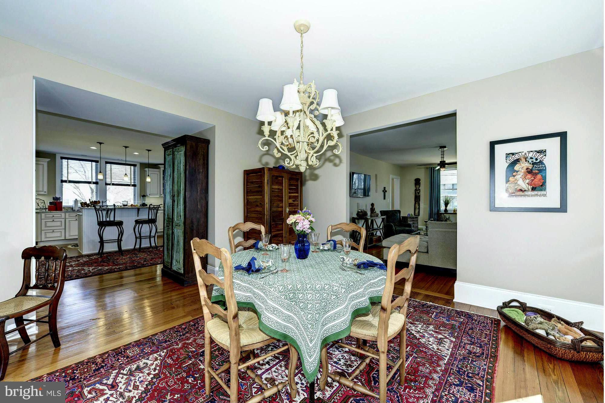 4048 Rectortown Road Marshall, VA 20115 - Photo 11 of 30 a dining room with wooden floor a chandelier a wooden table and chairs