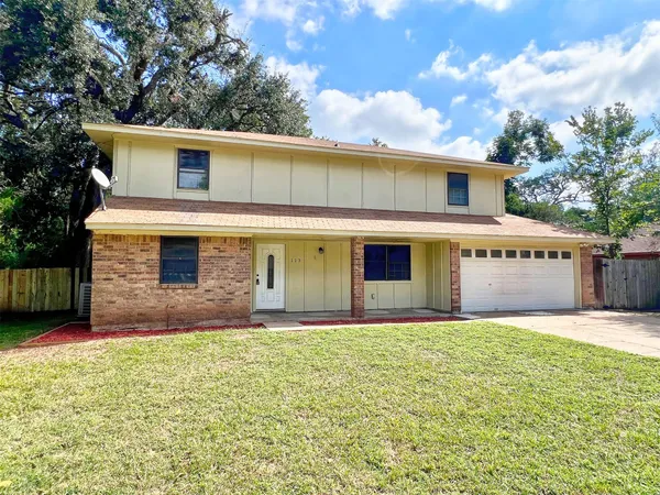 a view of a house with a yard and garage