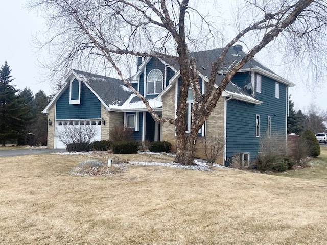1702 Elm Street Spring Grove, IL 60081 - Photo 29 of 30 a front view of a house with a yard covered in snow
