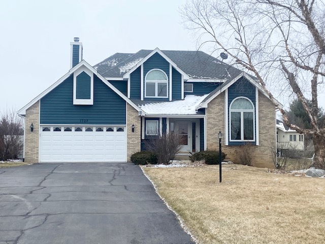 1702 Elm Street Spring Grove, IL 60081 - Photo 30 of 30 a front view of a house with a yard and garage