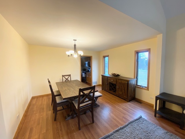 1702 Elm Street Spring Grove, IL 60081 - Photo 4 of 30 a view of a dining room with furniture and wooden floor