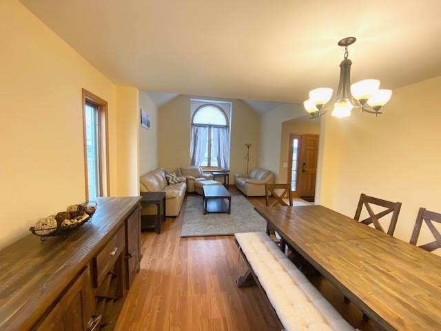 1702 Elm Street Spring Grove, IL 60081 - Photo 6 of 30 a living room with couches chairs and a large mirror with wooden floor