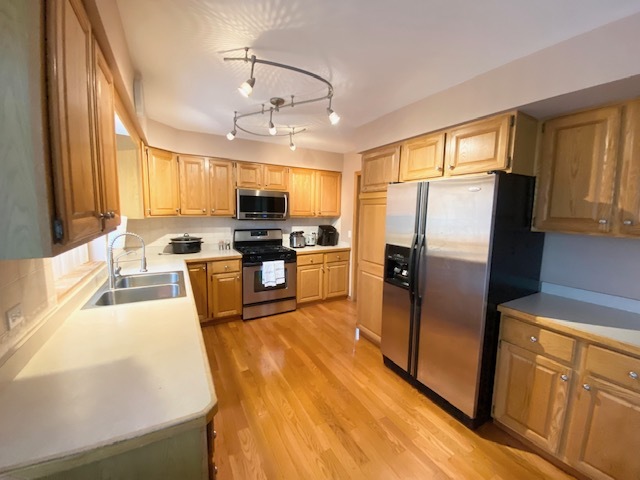 1702 Elm Street Spring Grove, IL 60081 - Photo 8 of 30 a kitchen with stainless steel appliances granite countertop a refrigerator stove microwave and sink