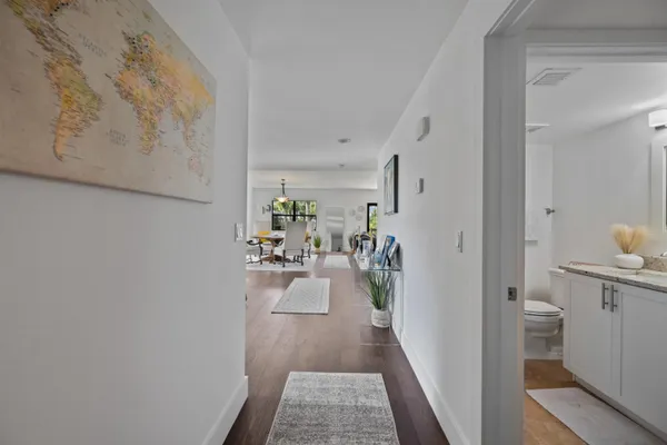 a view of a hallway and a livingroom with furniture