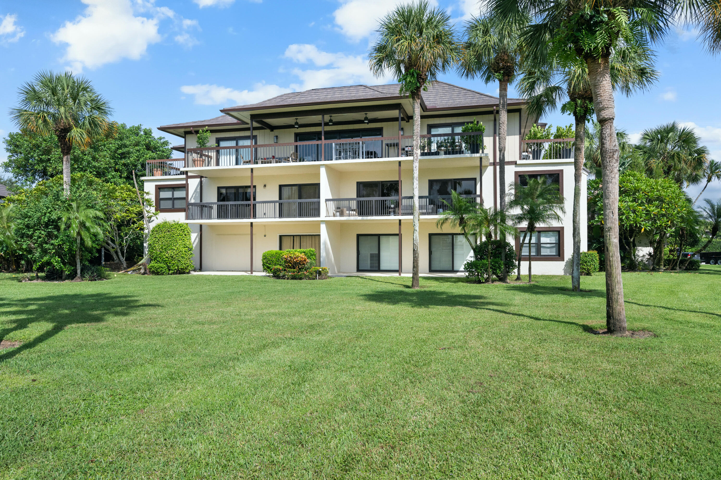 13388 Polo Road West, Unit 201 Wellington, FL 33414 - Photo 16 of 19 front view of house with a yard