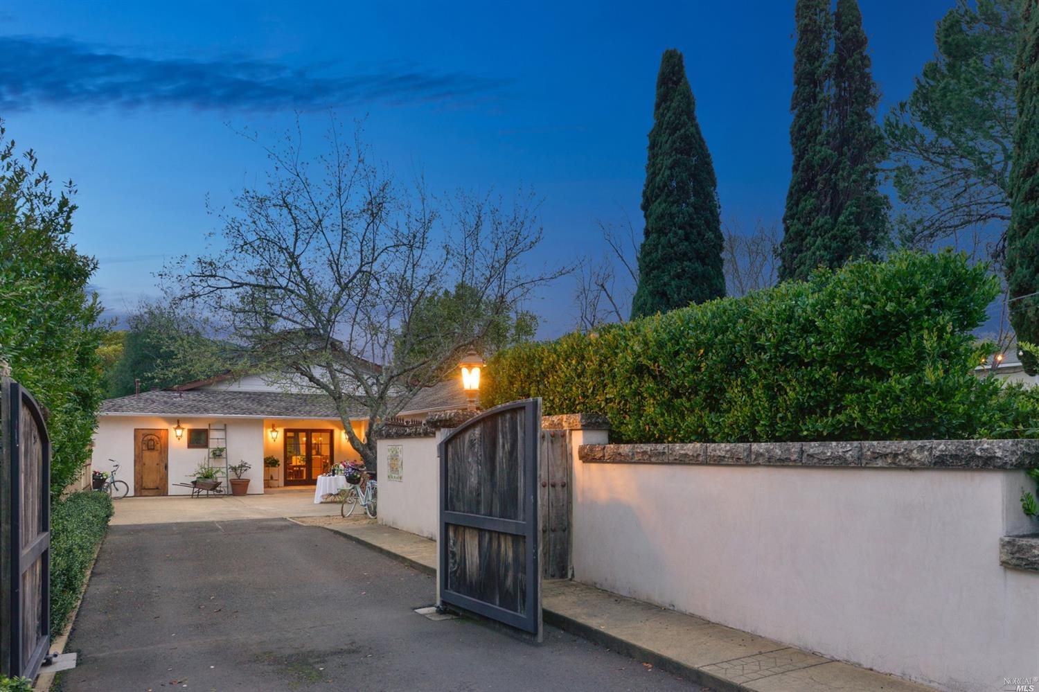 a view of a street with a house in the background