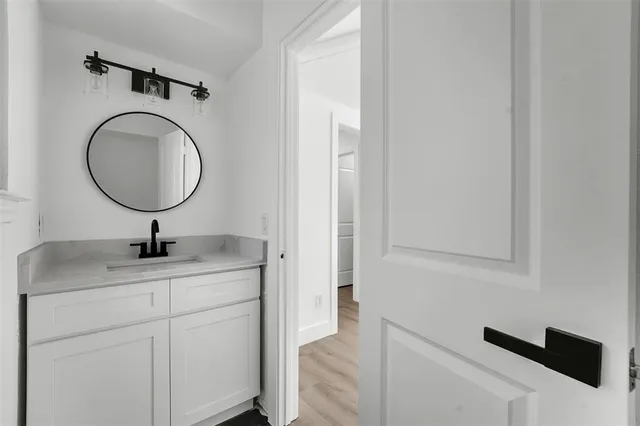 a bathroom with a sink a vanity and a mirror