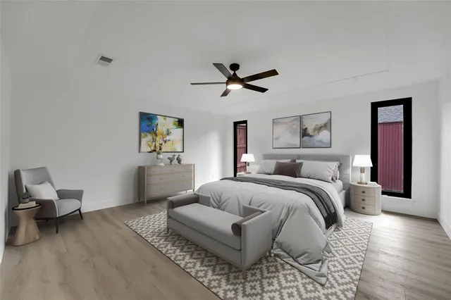 a bedroom with a bed couches and window