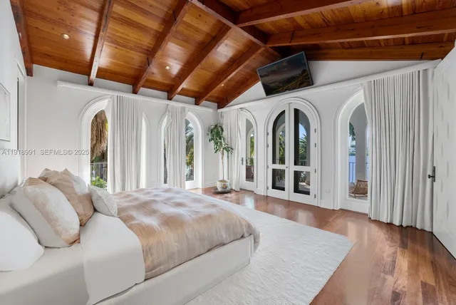 a bed room with a bed and a large window