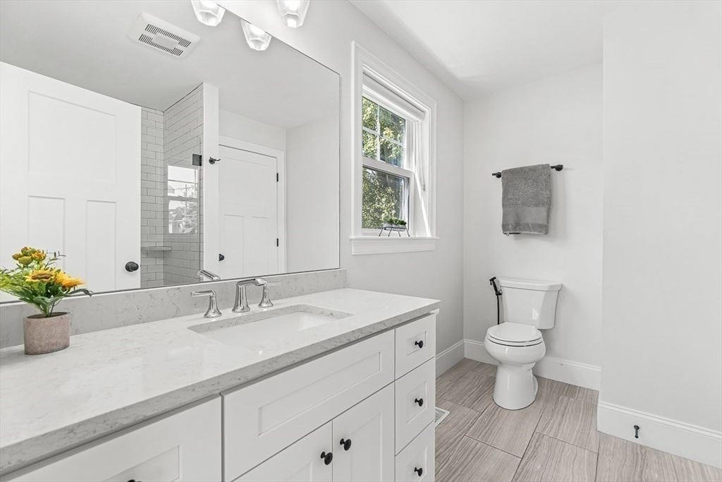 237 Swanton Street Winchester, MA 01890 - Photo 14 of 34 a bathroom with a sink a toilet and a mirror
