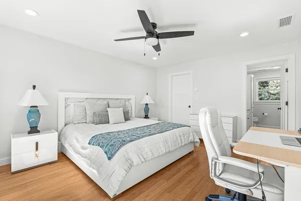 a bedroom with a bed a table and chair