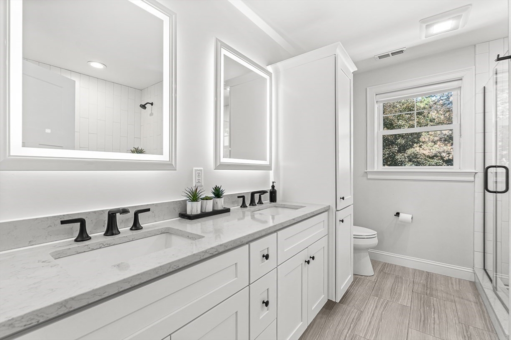 237 Swanton Street Winchester, MA 01890 - Photo 18 of 34 a bathroom with double vanity sink a mirror and a shower