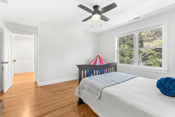 a bedroom with a bed and a chandelier
