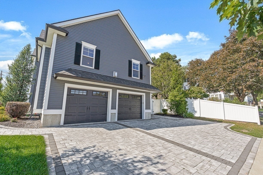237 Swanton Street Winchester, MA 01890 - Photo 29 of 34 a front view of a house with a yard and garage