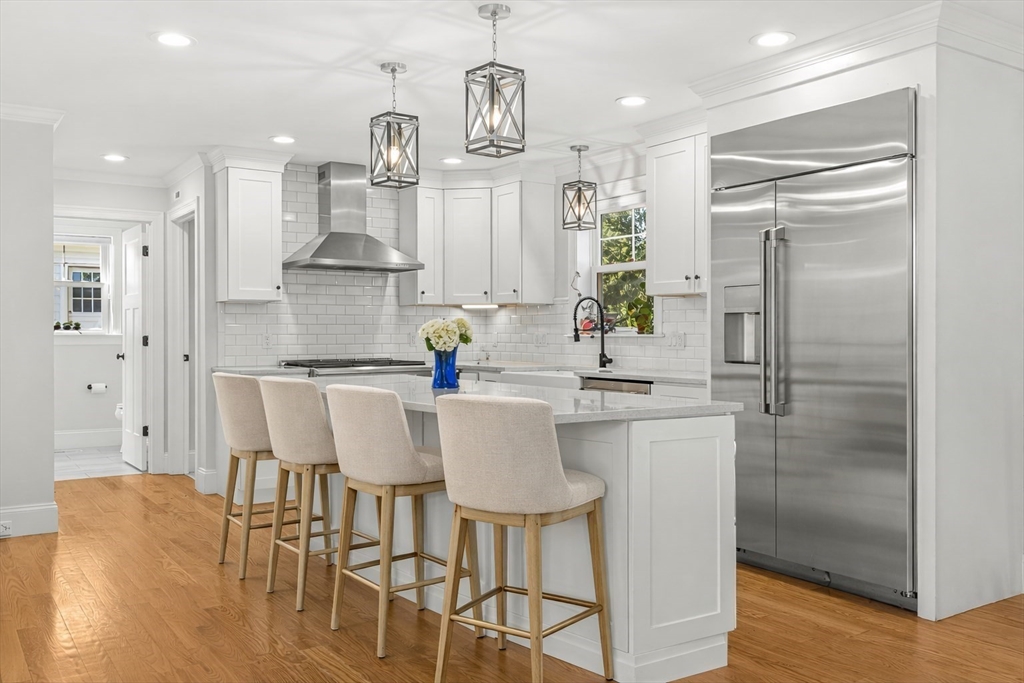 237 Swanton Street Winchester, MA 01890 - Photo 3 of 34 a kitchen with stainless steel appliances kitchen island granite countertop a refrigerator and a sink