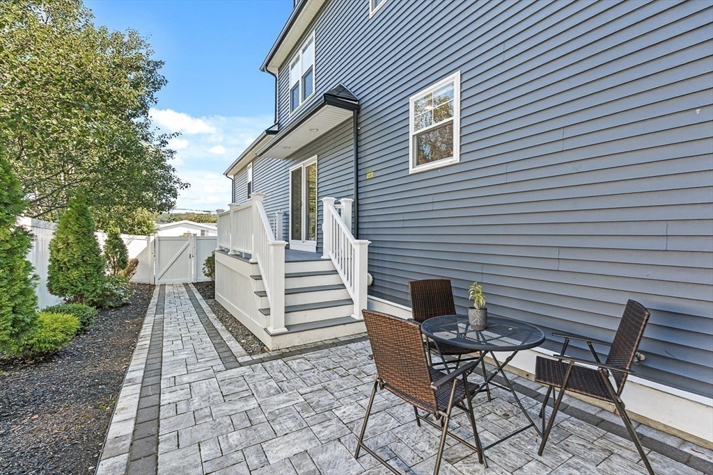 237 Swanton Street Winchester, MA 01890 - Photo 32 of 34 a view of a patio with a table and chairs and couches