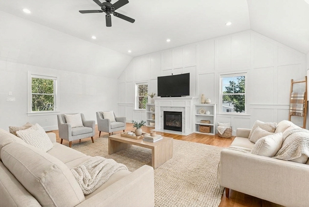 237 Swanton Street Winchester, MA 01890 - Photo 6 of 34 a living room with furniture a fireplace and a flat screen tv