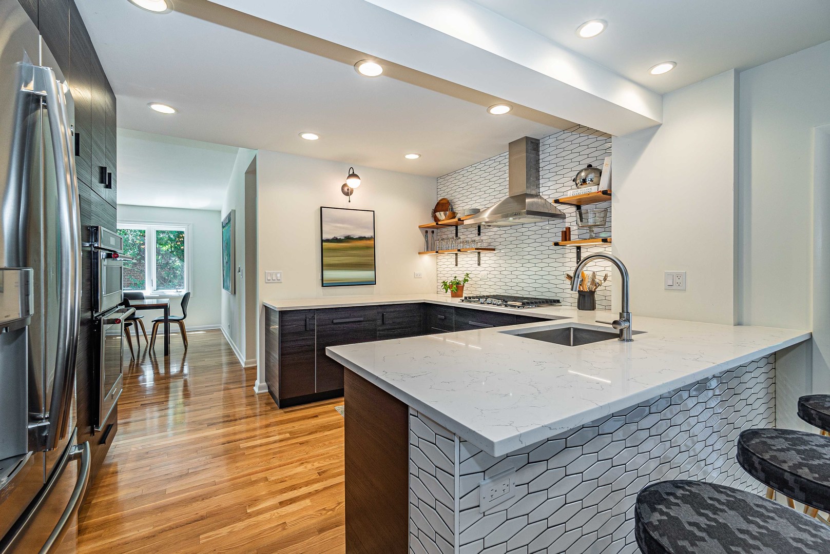 1146 Rago Avenue Deerfield, IL 60015 - Photo 7 of 25 a kitchen with kitchen island a stove a sink a dining table and chairs