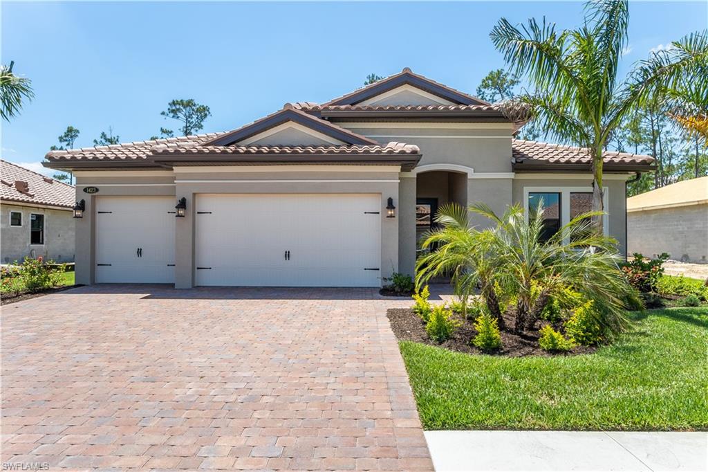 a front view of a house with a yard and garage