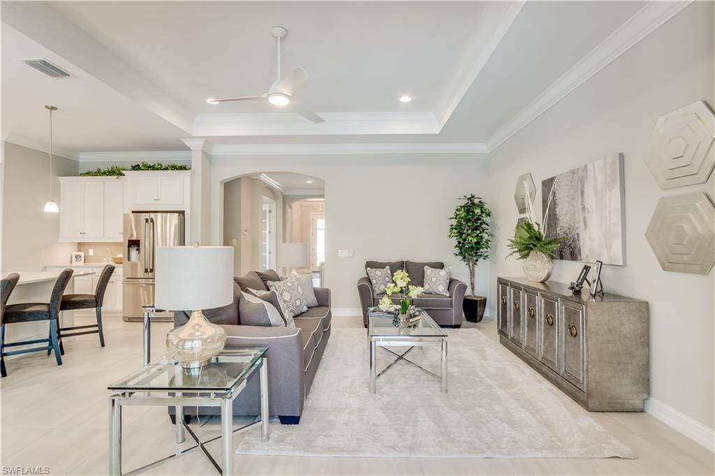 1423 Mockingbird Drive Naples, FL 34120 - Photo 11 of 26 a living room with furniture and a potted plant