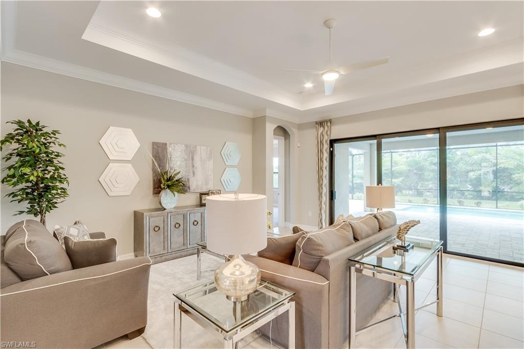 1423 Mockingbird Drive Naples, FL 34120 - Photo 13 of 26 a living room with furniture and a large window