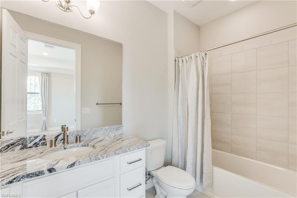 1423 Mockingbird Drive Naples, FL 34120 - Photo 21 of 26 a bathroom with a granite countertop sink toilet and shower