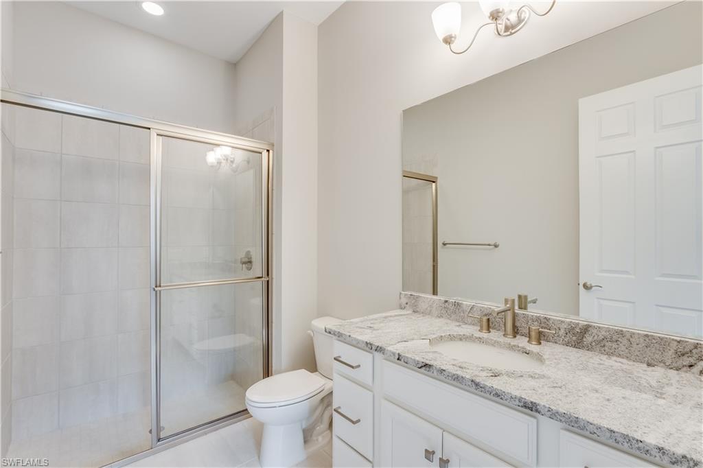 1423 Mockingbird Drive Naples, FL 34120 - Photo 25 of 26 a bathroom with a granite countertop sink toilet and shower