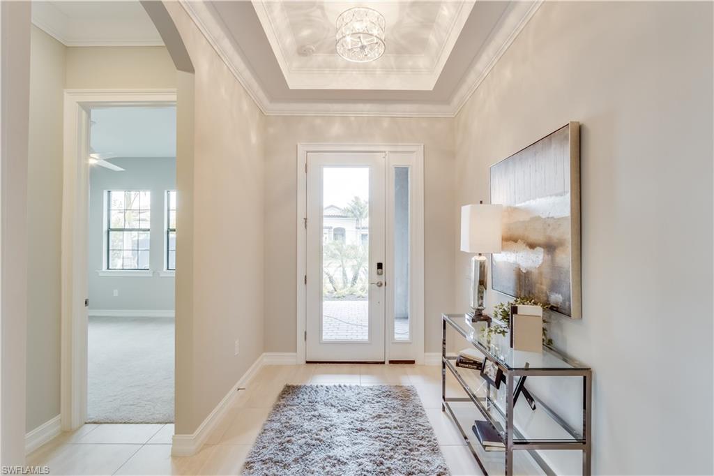 1423 Mockingbird Drive Naples, FL 34120 - Photo 26 of 26 a view of a hallway with a livingroom and a mirror