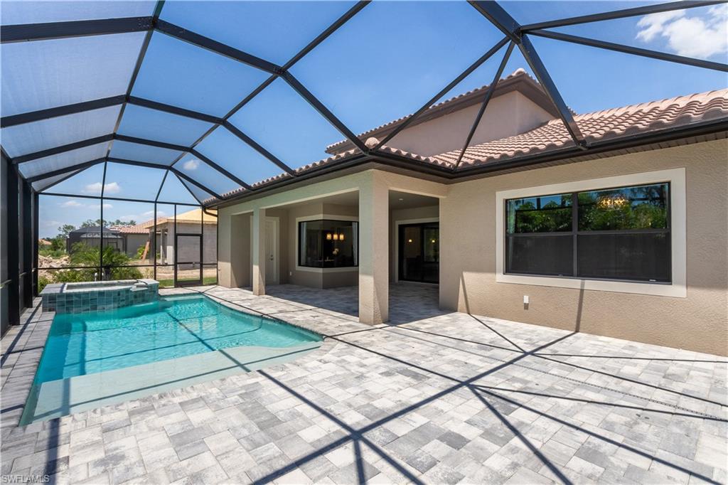 1423 Mockingbird Drive Naples, FL 34120 - Photo 4 of 26 a view of a patio with a table and chairs under an umbrella