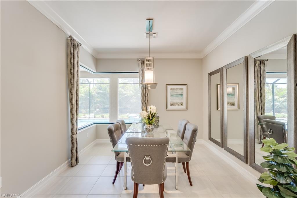 1423 Mockingbird Drive Naples, FL 34120 - Photo 9 of 26 a dining room with furniture potted plants and wooden floor