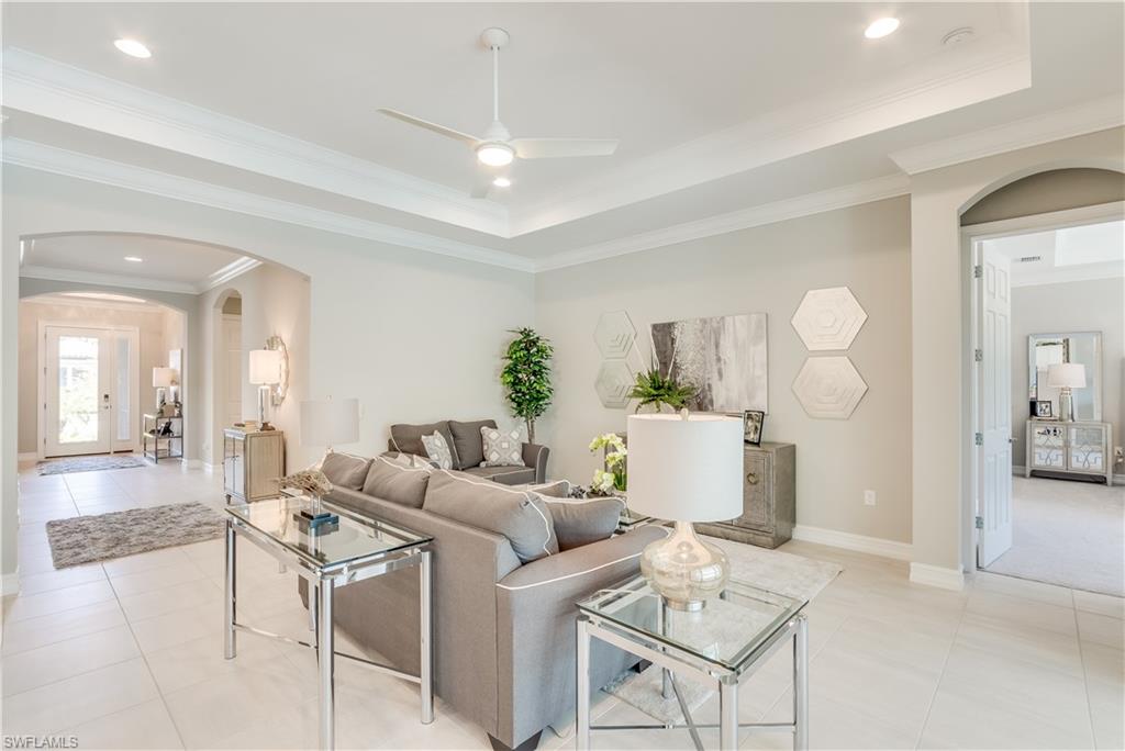 1423 Mockingbird Drive Naples, FL 34120 - Photo 10 of 26 a living room with furniture a dining table and chairs