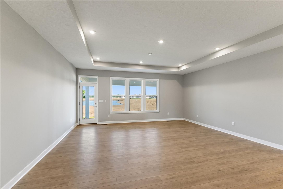407 South Landon Lane Springfield, OH 45502 - Photo 6 of 30 This living area features a decorative tray ceiling and durable laminate flooring, offering expansive views.