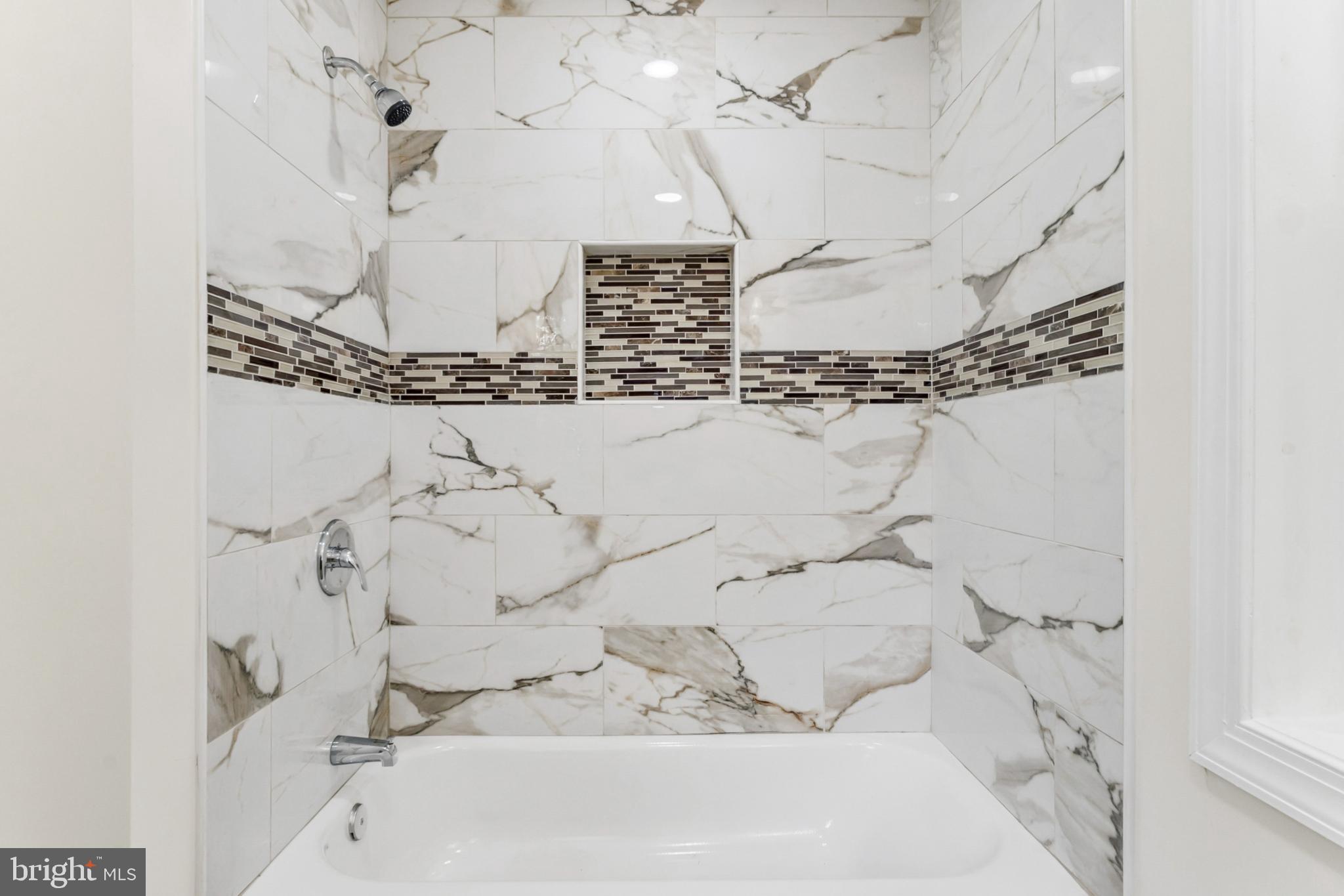 6804 Carol Road Baltimore, MD 21207 - Photo 12 of 25 Elegant marble shower with stylish accents.