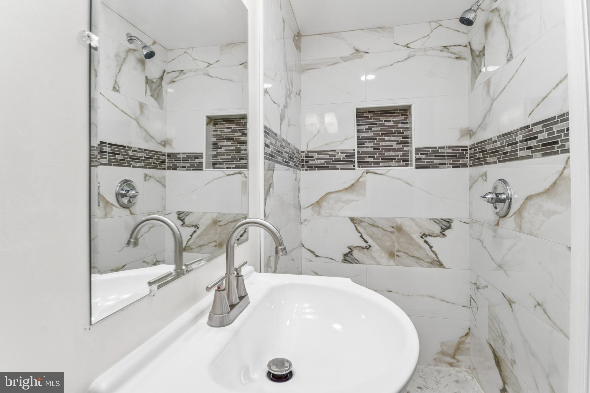 6804 Carol Road Baltimore, MD 21207 - Photo 14 of 25 Elegant marble accents in a modern bath.