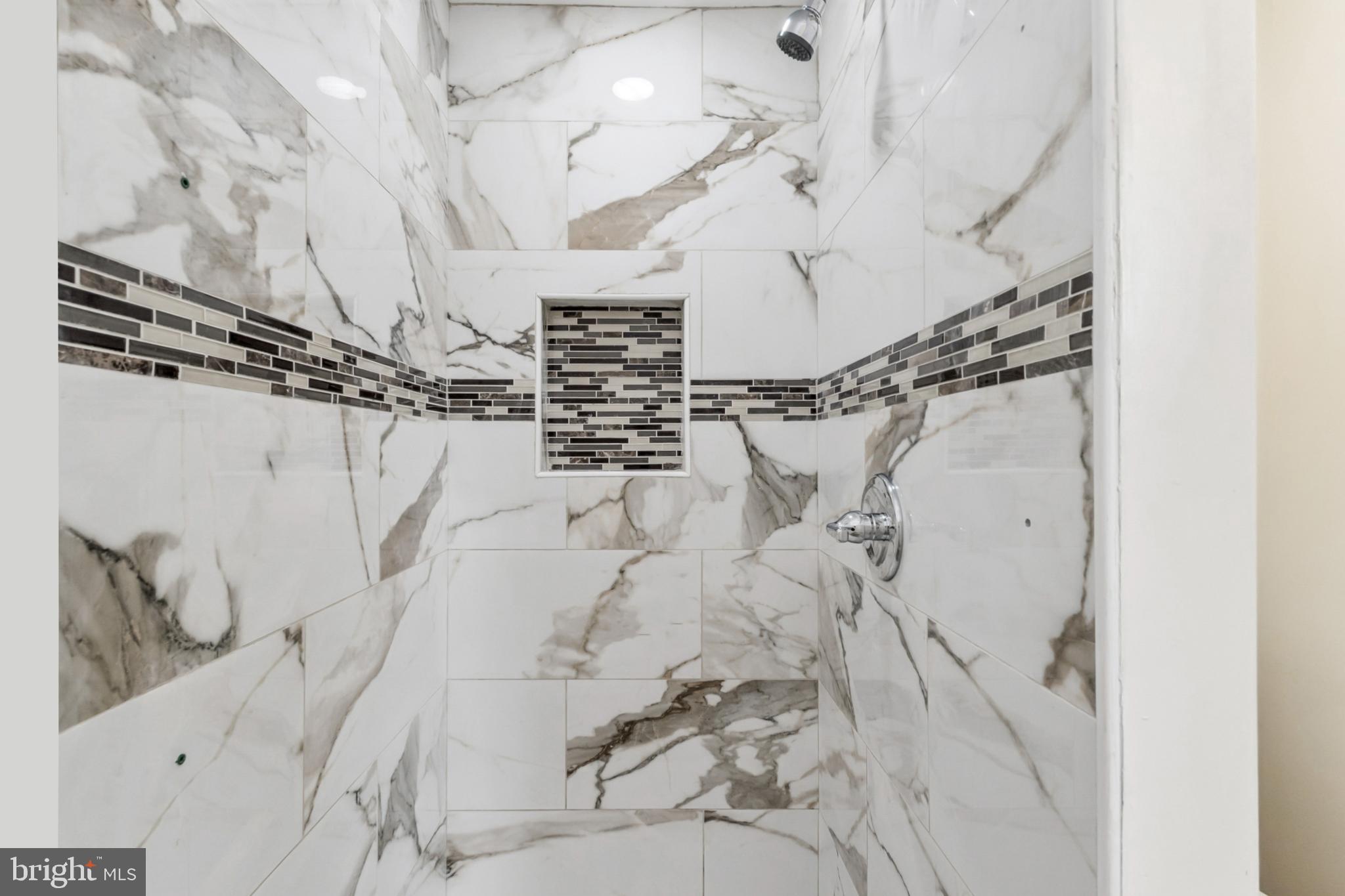 6804 Carol Road Baltimore, MD 21207 - Photo 15 of 25 Elegant marble shower with stylish accents.