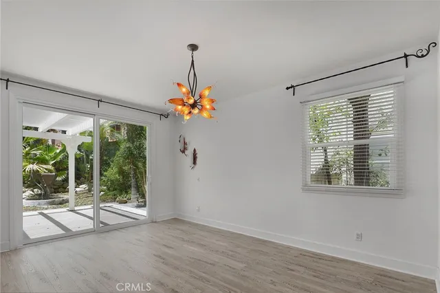a view of a room with wooden floor staircase and a chandelier