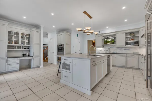 a kitchen with a sink cabinets and window